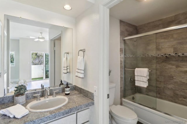 full bathroom featuring toilet, vanity, and combined bath / shower with glass door