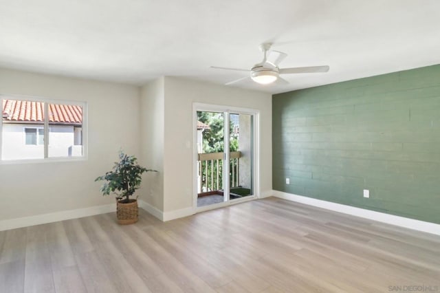 spare room with ceiling fan and light hardwood / wood-style flooring