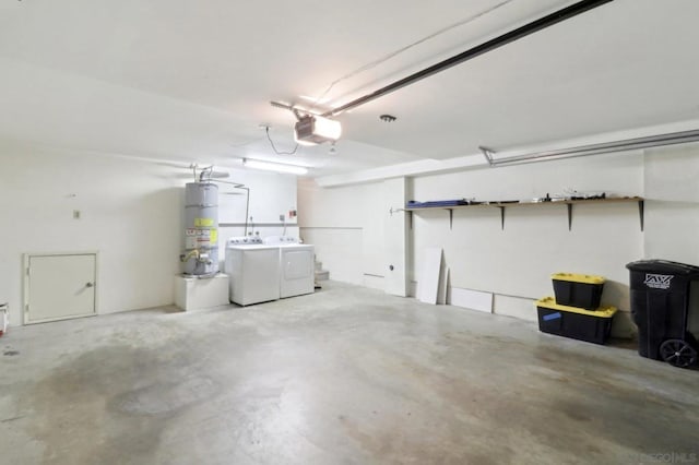 garage with gas water heater, independent washer and dryer, and a garage door opener