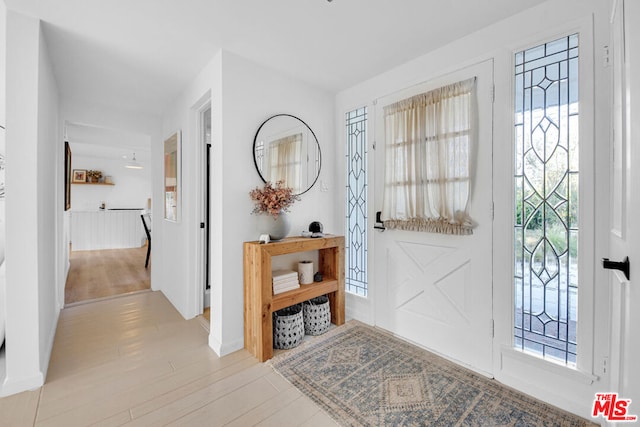 entrance foyer with a healthy amount of sunlight and light hardwood / wood-style flooring