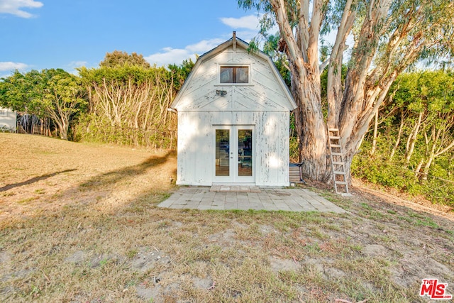 view of outbuilding featuring a lawn