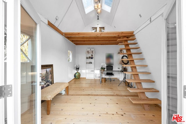 foyer featuring high vaulted ceiling and a skylight