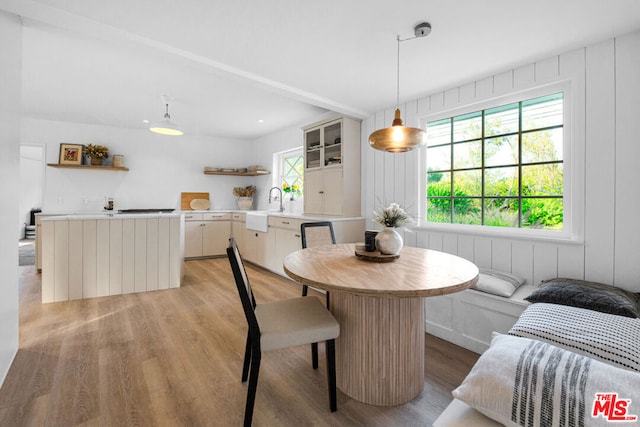 dining space featuring sink and light hardwood / wood-style flooring