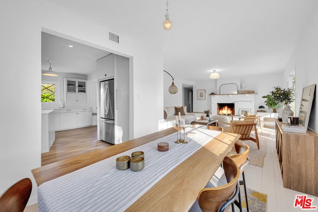 dining room with a brick fireplace