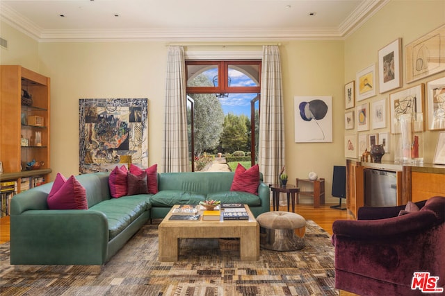 living room with bar area, crown molding, and hardwood / wood-style floors