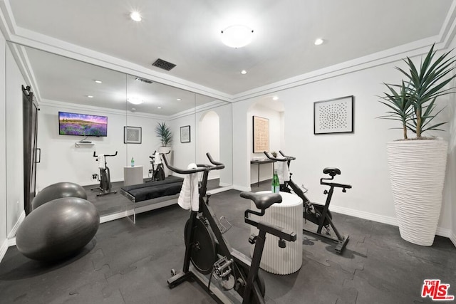 workout room featuring ornamental molding