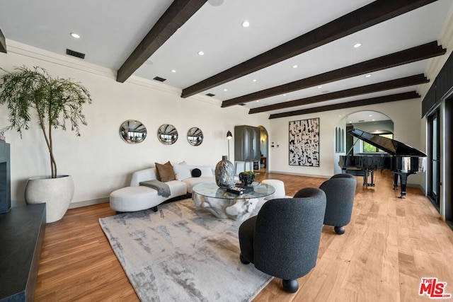 living room with beam ceiling and light wood-type flooring