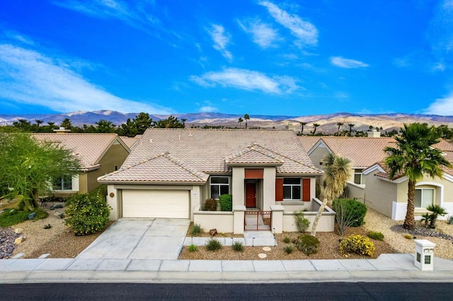 view of front of house featuring a mountain view and a garage