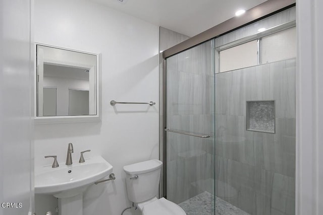 bathroom featuring sink, toilet, and walk in shower