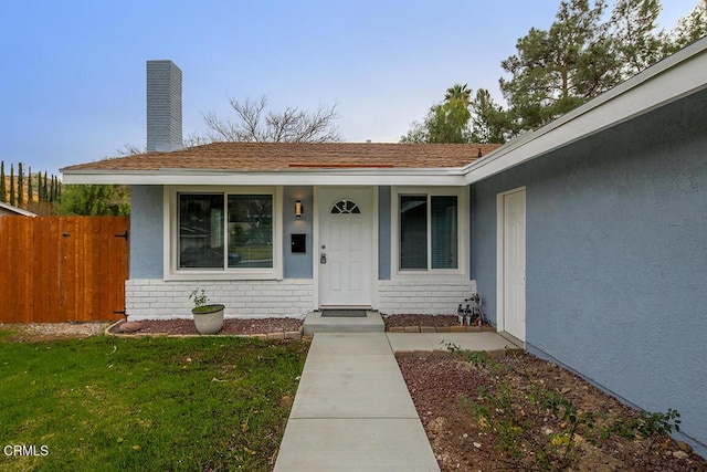 doorway to property with a yard