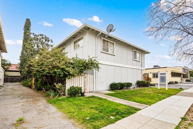 view of side of property with a yard