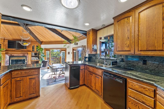 kitchen featuring pendant lighting, sink, black dishwasher, lofted ceiling with beams, and kitchen peninsula