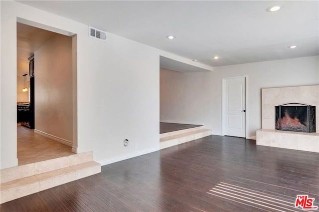 unfurnished living room featuring hardwood / wood-style floors and a premium fireplace