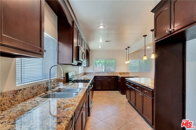 kitchen with light stone countertops, dark brown cabinetry, decorative light fixtures, stainless steel appliances, and sink