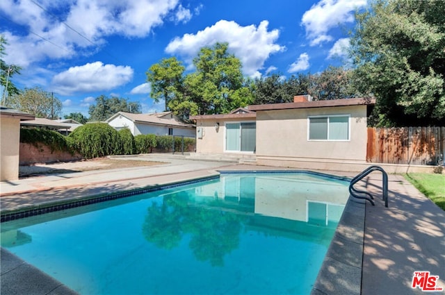 view of swimming pool with a patio area