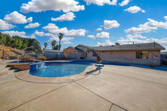 view of pool with a patio and an in ground hot tub