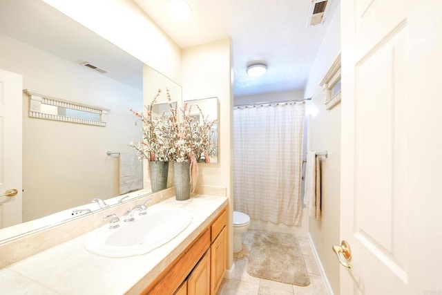 full bathroom with tile patterned floors, toilet, vanity, and shower / tub combo