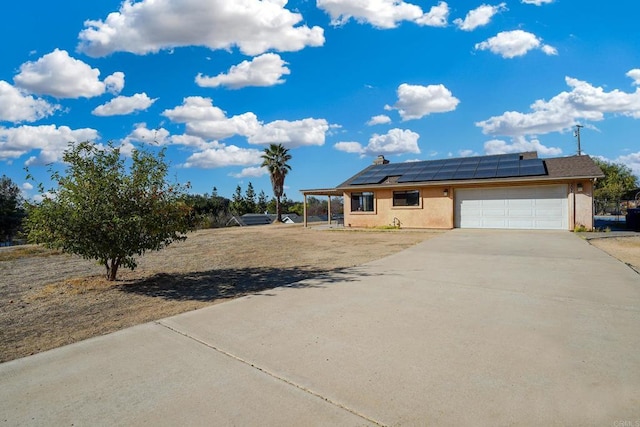 view of front of house with a garage and solar panels