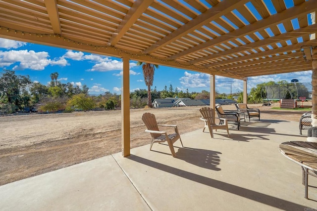 view of patio / terrace featuring a pergola and a trampoline