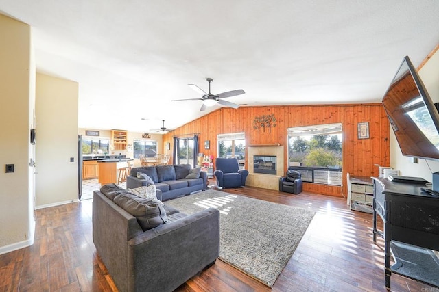 living room featuring lofted ceiling, ceiling fan, and dark hardwood / wood-style flooring