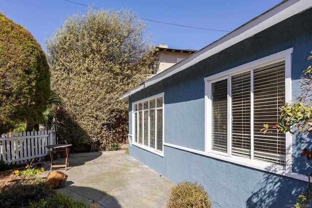 view of side of home featuring a patio