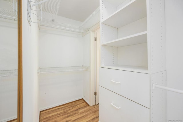 walk in closet featuring hardwood / wood-style flooring