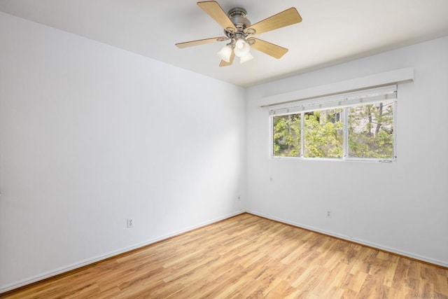 spare room with light hardwood / wood-style flooring and ceiling fan