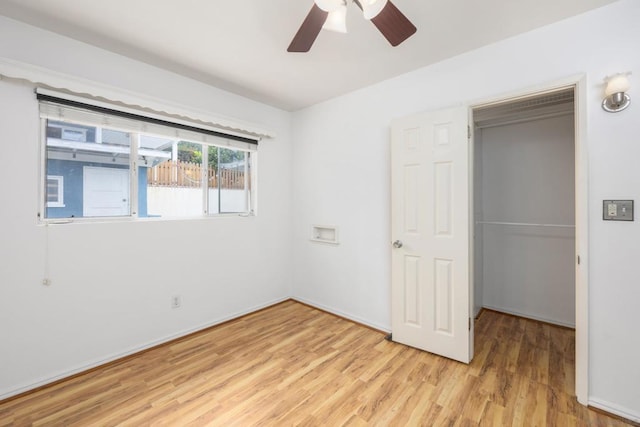 unfurnished bedroom with ceiling fan, a closet, and light wood-type flooring