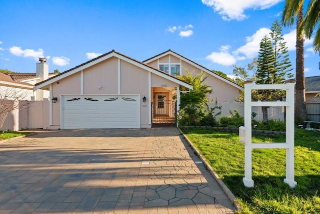 view of front of property featuring a garage and a front yard