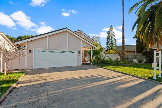 view of front of home with a garage and a front lawn