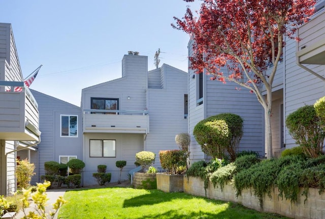 rear view of house featuring a lawn