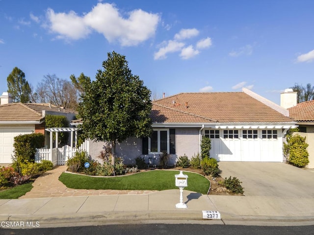 view of front of property with a front lawn and a garage