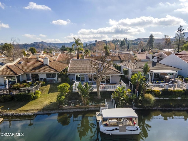 birds eye view of property featuring a water and mountain view