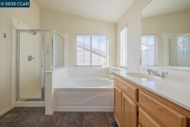 bathroom with vanity, vaulted ceiling, and shower with separate bathtub