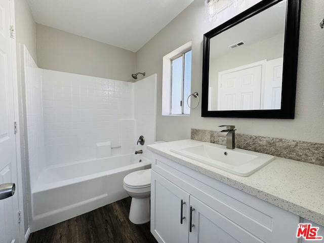 full bathroom with shower / bathtub combination, hardwood / wood-style floors, toilet, and vanity