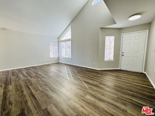 foyer entrance featuring dark hardwood / wood-style floors and vaulted ceiling