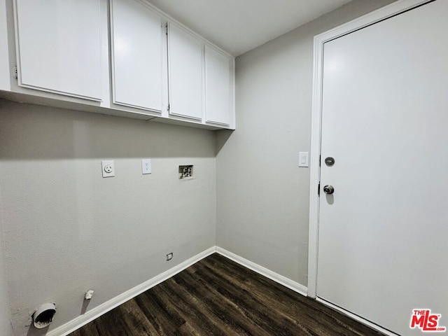 laundry area with gas dryer hookup, hookup for a washing machine, dark wood-type flooring, electric dryer hookup, and cabinets