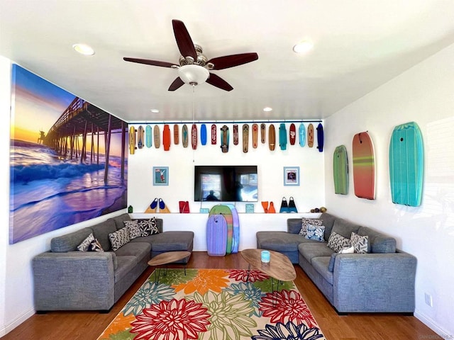 living room featuring ceiling fan and hardwood / wood-style floors