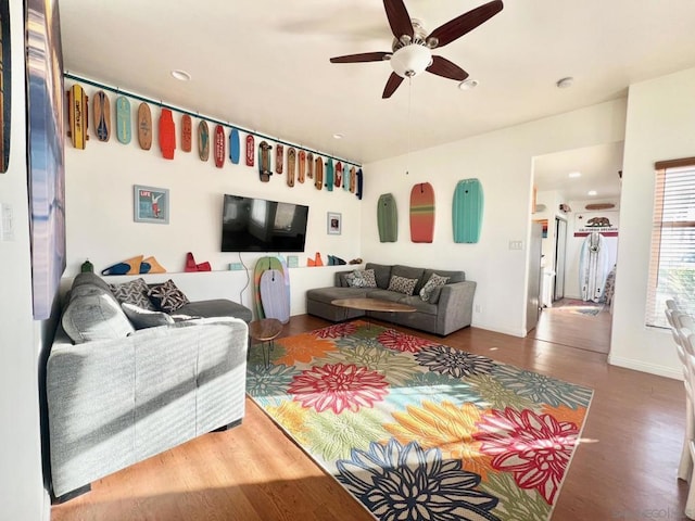 living room featuring ceiling fan and wood-type flooring