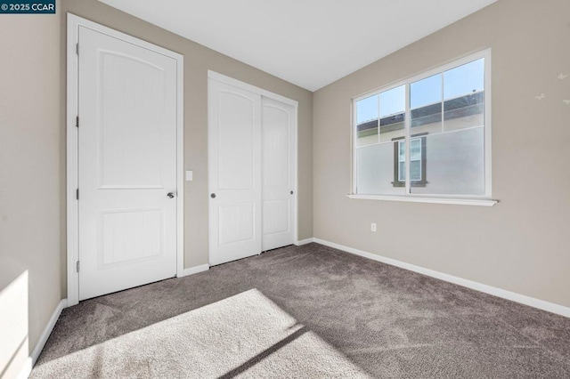 unfurnished bedroom featuring a closet and carpet flooring