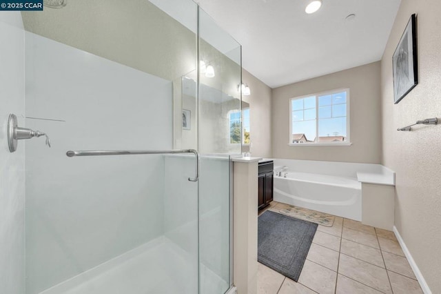 bathroom with vanity, tile patterned flooring, and shower with separate bathtub