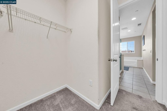 walk in closet featuring carpet flooring