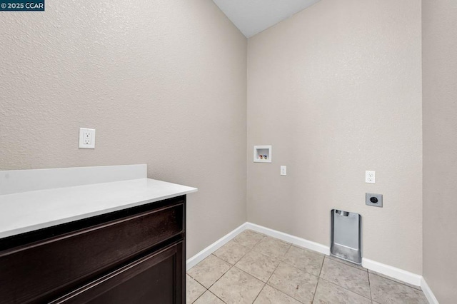 washroom with light tile patterned floors, hookup for a washing machine, and electric dryer hookup