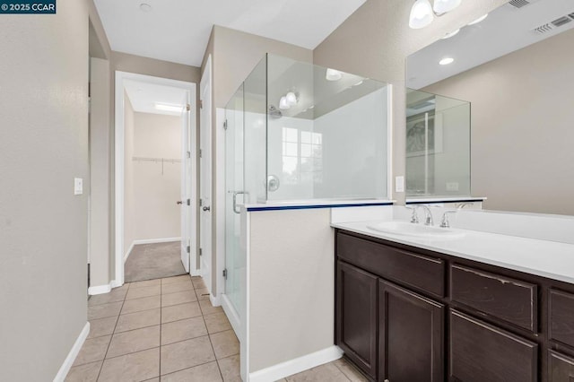 bathroom featuring tile patterned floors, vanity, and an enclosed shower