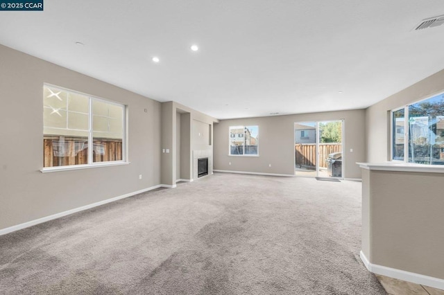 unfurnished living room featuring light carpet