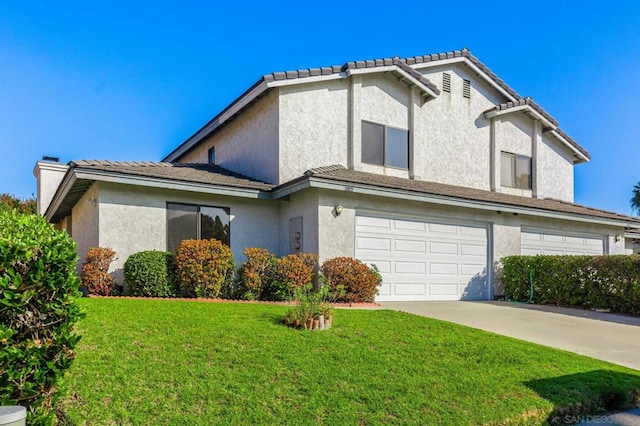 view of front of home with a front yard and a garage