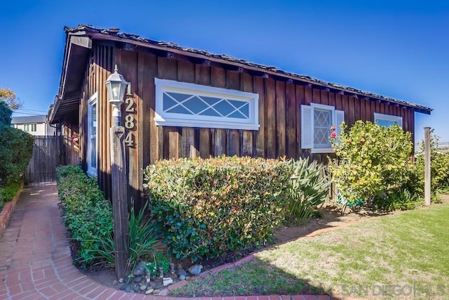 view of side of home featuring a lawn