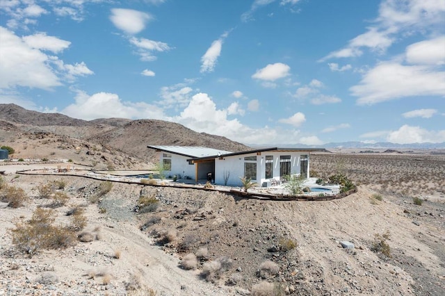 rear view of property with a mountain view