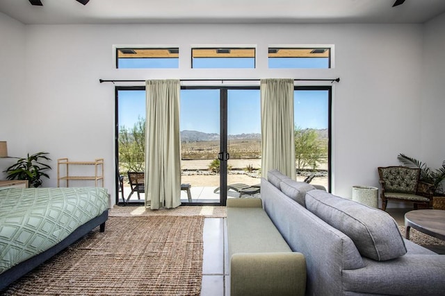 bedroom featuring ceiling fan and access to exterior