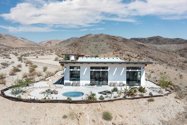 back of property featuring a mountain view